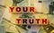 Your truth word written on wooden cubes laying on 100 Euro bills. Earning first money storytelling concept