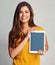 Your website would look wonderful here. Studio portrait of an attractive young woman holding a digital tablet with a