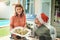 Youre all I wished for this Christmas. a beautiful young couple dishing up food together at a Christmas lunch party.