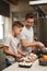 Youre doing great, bud. a young boy helping his father cook in the kitchen.