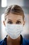 Youre in good hands. Closeup of a female surgeon wearing a surgical mask- portrait.