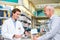 Youre good to go. a handsome young male pharmacist helping a customer in the pharmacy.