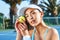 Youre looking at the winning ball. an attractive young woman standing and holding a tennis ball while looking