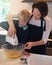 Youre never too young to learn to bake. a mother teaching her little boy how to bake in their kitchen at home.