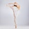 Youre not truly free until you dance. Studio shot of a young woman performing a ballet recital against a grey background