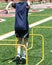 Youth athlete jumping over two foot yellow hurdles