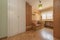 Youth bedroom with pine wood furniture with matching shelves, desk and cabinets, one matching and one white built into the wall