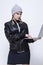 Youth Lifestyles. Caucasian Blond Femalr in Warm Hat and Leather Jacket Posing With Laptop With Ingratiating facial Expression on