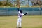 Youth outfielder catching ball