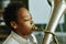 Youthful African American schoolboy blowing trumpet during music lesson