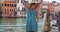 Youthful black female shows off dance moves outside in Venice, Italy