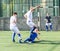 Youthful football player tackling ball