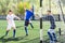 Youthful football players challenging for ball