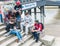 Youthful friends sit on stone steps leading to Thames River, at