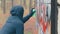 Youthful Guy Drawing Graffiti Using Spray Paint Can