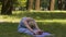 Youthful lady stretching in park on mat, yoga asana amateur, good shape slow-mo