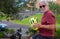 Youthful senior man in activity with bicycle in urban street. Attractive white-haired elderly retiree enjoying retirement