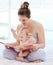 A youthful song of laughter. a young mother bonding with her baby boy while reading a book at home.