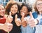 Youve got our vote. Cropped portrait of a diverse group of college friends giving thumbs up while standing outside.