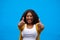 Youve got it right. Cropped portrait of an attractive young woman showing thumbs up against a blue background.