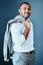 Youve got to look the part of a successful man. Studio portrait of a young businessman standing against a grey