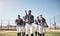 Youve gotta have grit to win this game. a group of young men walking onto a baseball field.