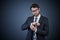 Youve gotta look your best. Studio portrait of a handsome young businessman adjusting his cuffs against a dark