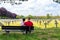 Ysselsteyn, Netherlands - May 23, 2019. A pair of young people sitting on a bench looking at concrete crosses at the German war ce