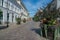 Ystad, Sweden - 24, Aug 2022: Cobblestone street in a smaller town in southern Sweden with plants decorating