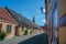 Ystad, Sweden - 24, Aug 2022: Colourful houses on a smaller street in a small town with the top of the church in the background