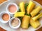 Yuca fries served on white plate with sauces