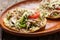 Yucatecan salbutes with chicken meat on wooden background