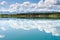 Yukon wilderness cloudscape reflected on calm lake