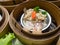 Yumcha or Dimsum, mantis shrimp and pork steamed dumpling in bamboo basket steamer in chinese restaurant