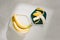 Yummy bananas and bowl with slices on wooden background