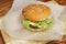 yummy burger. serving cheeseburger or hamburger with salad tomatoes onion on wooden desk. catering in food court at mall concept