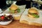 yummy burger. serving cheeseburger or hamburger with salad on wooden desk. catering in food court at mall concept. space for text
