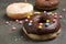 Yummy donut with colorful sprinkles on table, closeup