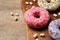 Yummy donuts with sprinkles and marshmallows on table, closeup