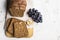 Yummy fresh bread with walnut and raisins on light background.