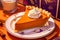 Yummy pie with sliced one piece on wooden surface