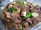 Yummy spicey mutton dish made with oil decorate with green chilies and lemons