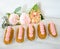 Yummy vanilla eclairs on wood with flower decoration