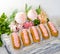 Yummy vanilla eclairs on wood with flower decoration