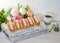 Yummy vanilla eclairs on wood with flower decoration