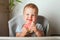 Yummy watermelon and little funny toddler in highchair. First feeding of child with watermelon