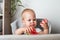 Yummy watermelon and little funny toddler in highchair. First feeding of child with watermelon