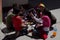 Yungay, Peru, August 4, 2014: group of Latino boys and girls with NGO workers doing a puppet workshop in a schoolyard