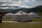 Yurt camp on a beautiful sunny day in Mongolia. Ger campsite in rural country, nature in the background