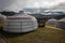 Yurt camp on a beautiful sunny day in Mongolia. Ger campsite in rural country, nature in the background